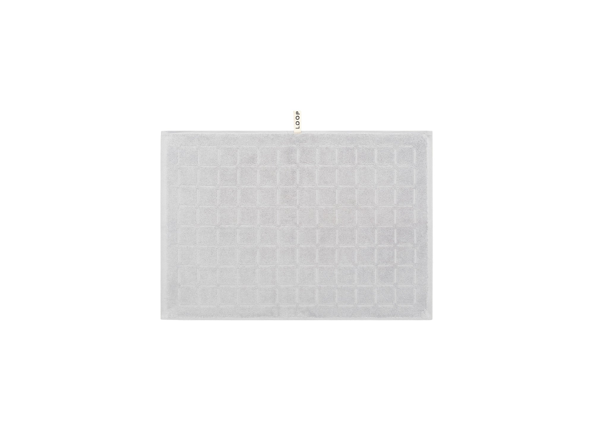 LOOP HOME stone hand towel neatly folded on plain background