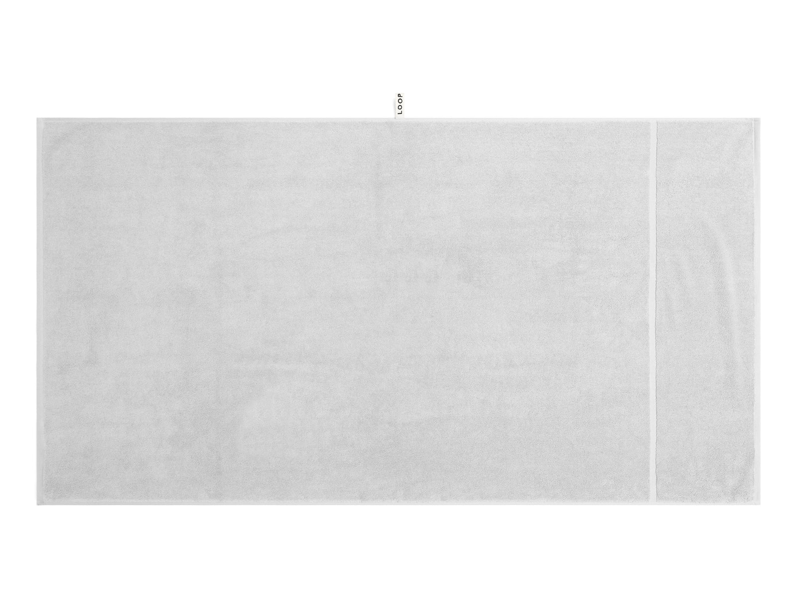 LOOP HOME stone bath sheet folded on plain background