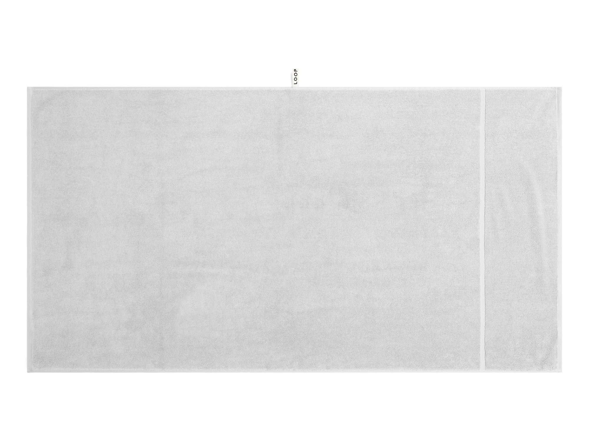 LOOP HOME stone bath sheet folded on plain background
